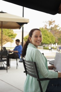 Students studying at tables on campus