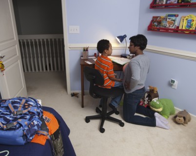 Mother helping son with homework