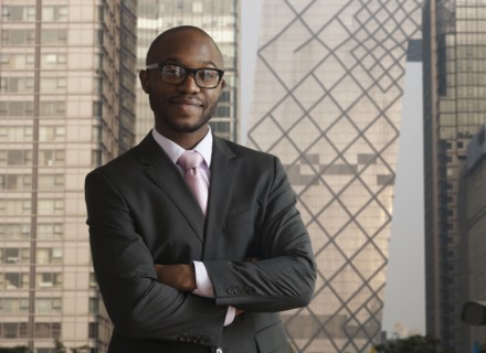 Black businessman smiling on city street