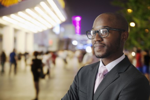 Black businessman smiling on city street