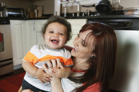 Mother and baby playing in kitchen