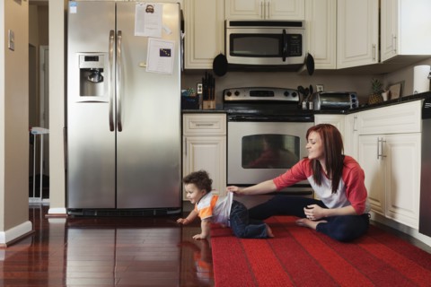 Mother and baby playing in kitchen