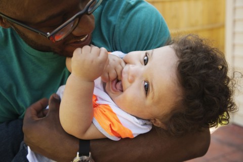 Father and baby playing outdoors
