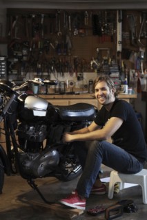 Caucasian mechanic working on motorcycle
