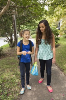 Mixed race girls walking to school