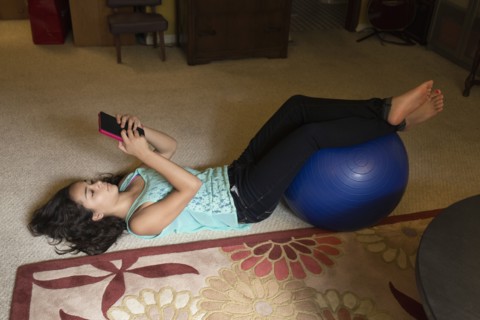 Mixed race girl using digital tablet on floor