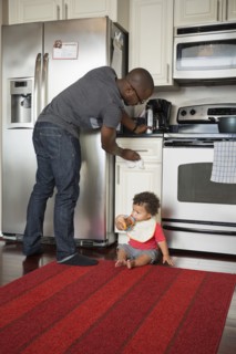 Father and toddler son in kitchen