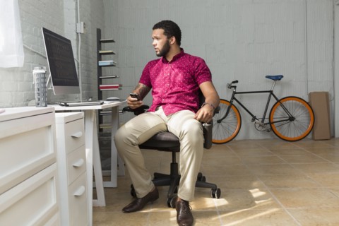 Mixed race businessman sitting at desk