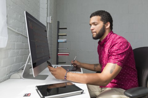 Mixed race businessman working at desk
