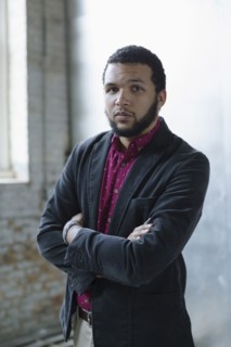 Mixed race businessman standing in warehouse