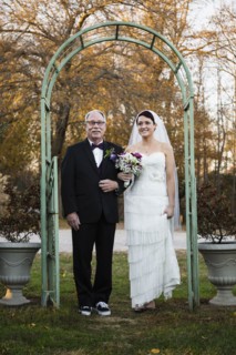 Caucasian father walking bride down aisle