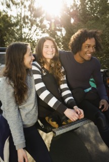 Friends sitting together in truck bed