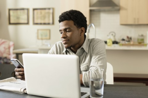 Black businessman working at breakfast table