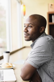 Black man relaxing in coffee shop