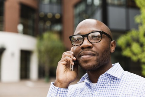 Black man talking on cell phone in city