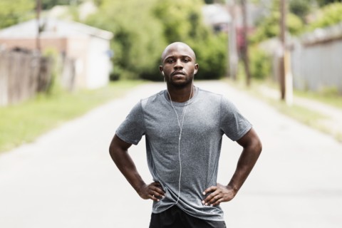 Black runner resting on city street