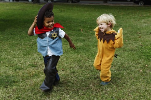 Boys playing in costumes in park