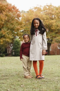 African American brother and sister smiling in park