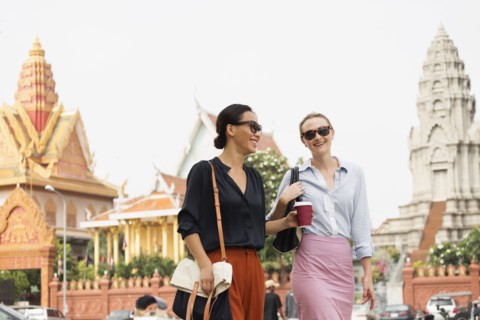Businesswomen walking by ornate temple