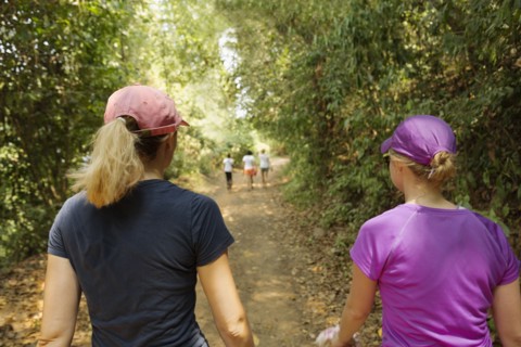 Women walking on remote dirt path