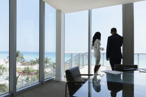 Business people looking out conference room window