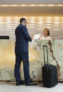 Businessman checking into hotel with concierge