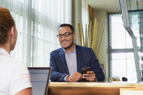 Businessman checking into hotel with concierge