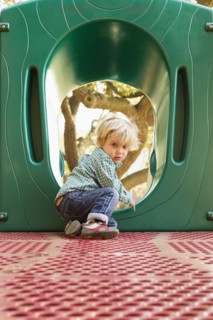 Caucasian boy climbing on play structure in playground