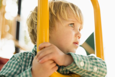 Caucasian boy on play structure in playground