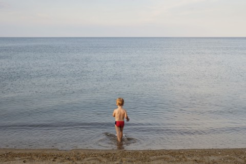 Caucasian boy playing on beach