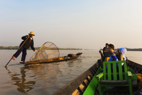 Tourists riding in canoe on rural lake
