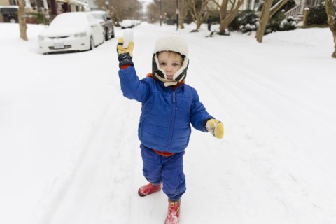 Caucasian boy throwing snowball