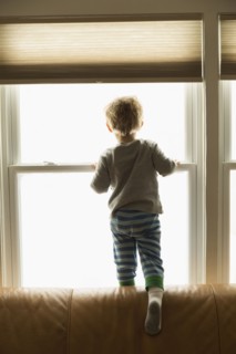 Caucasian boy looking out window