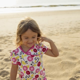 Mixed race girl smiling on beach