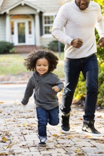 Father and son playing in driveway