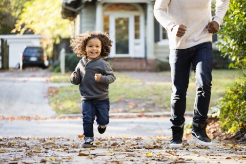 Father and son playing in driveway