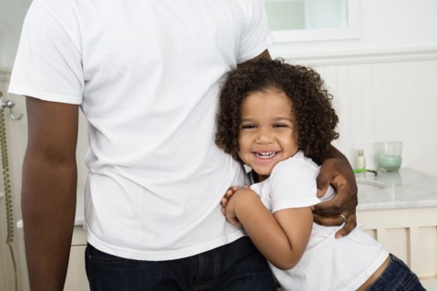Father and son hugging in bathroom