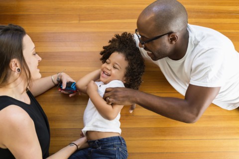 Family playing on floor