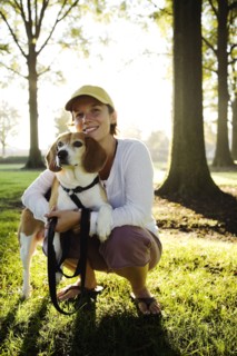 Caucasian woman hugging dog in park
