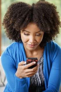 Black woman texting on cell phone