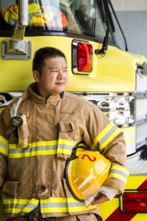 Chinese fireman standing near fire trucks