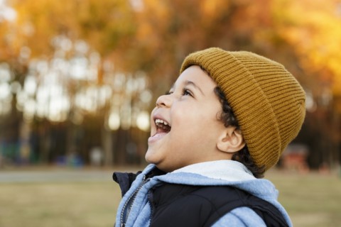 Mixed Race boy laughing in park