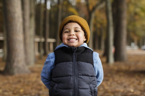 Portrait of smiling Mixed Race boy in park