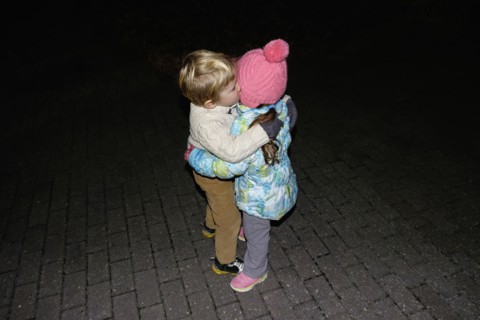 Boy ad girl hugging outdoors at night