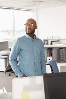 Smiling African American man standing in office