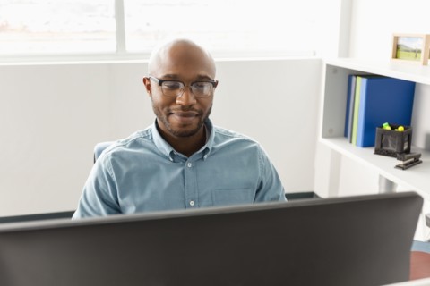 African American man using computer in office