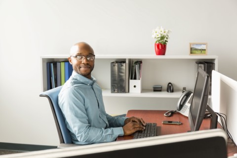 African American man using computer in office