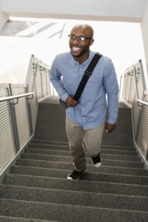 African American man climbing staircase