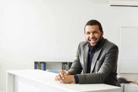 Mixed Race man smiling in office