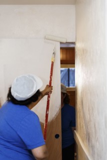 Native American woman painting wall